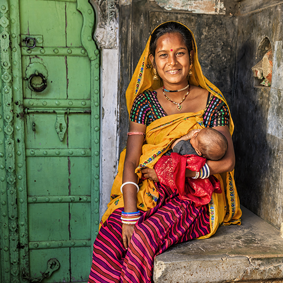 Young Indian mother breastfeeding her newborn child, Amber near Jaipur, Rajasthan, India.